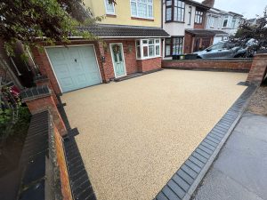 Installation of resin driveway across south birmingham. Black block paving border and gold resin inner.