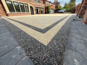 Large resin driveway installed to a house in Solihull. Gun metal grey double border with gold inner.
